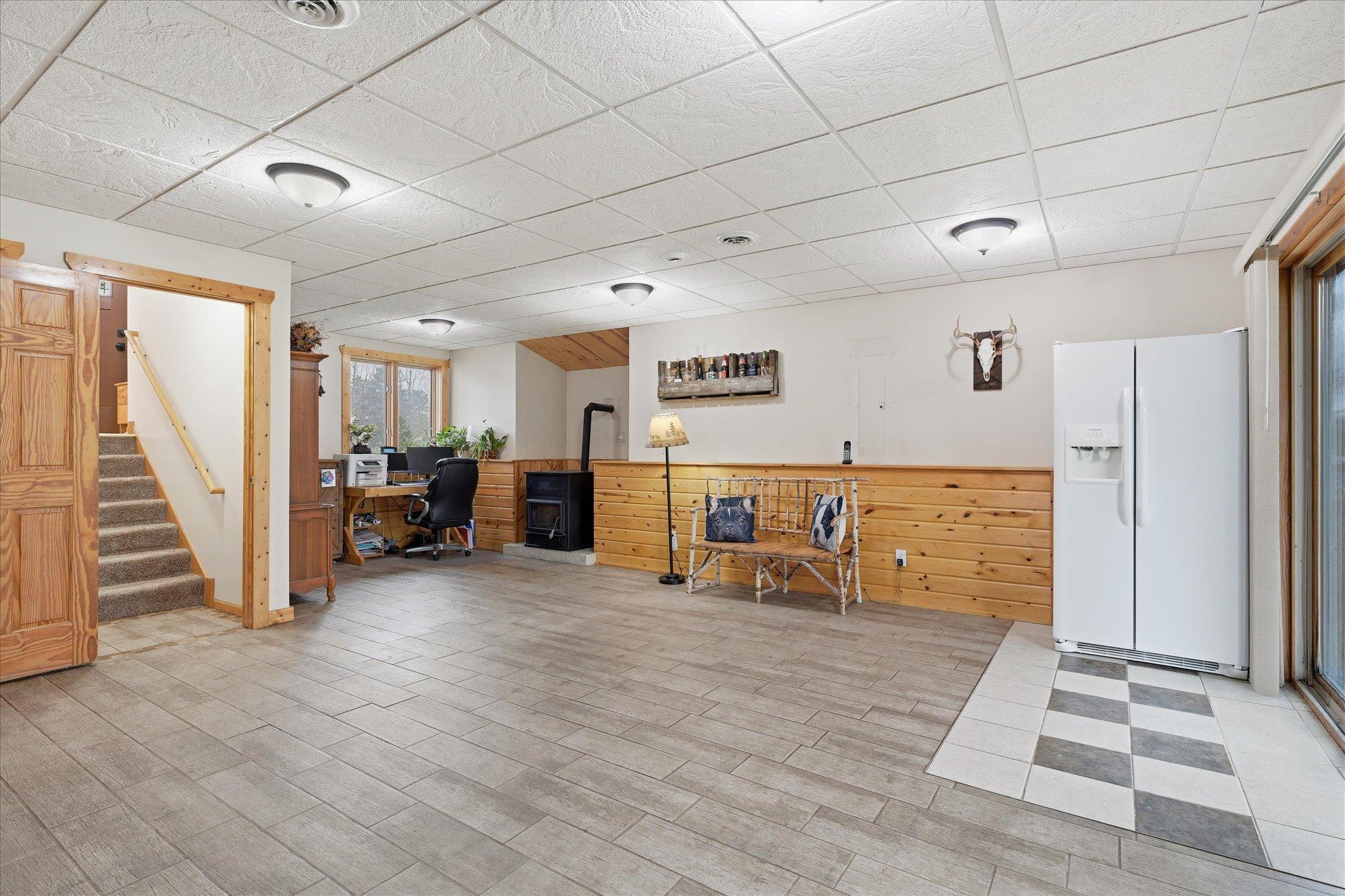 Spacious lower-level family room with a cozy pellet stove that adds warmth to the space