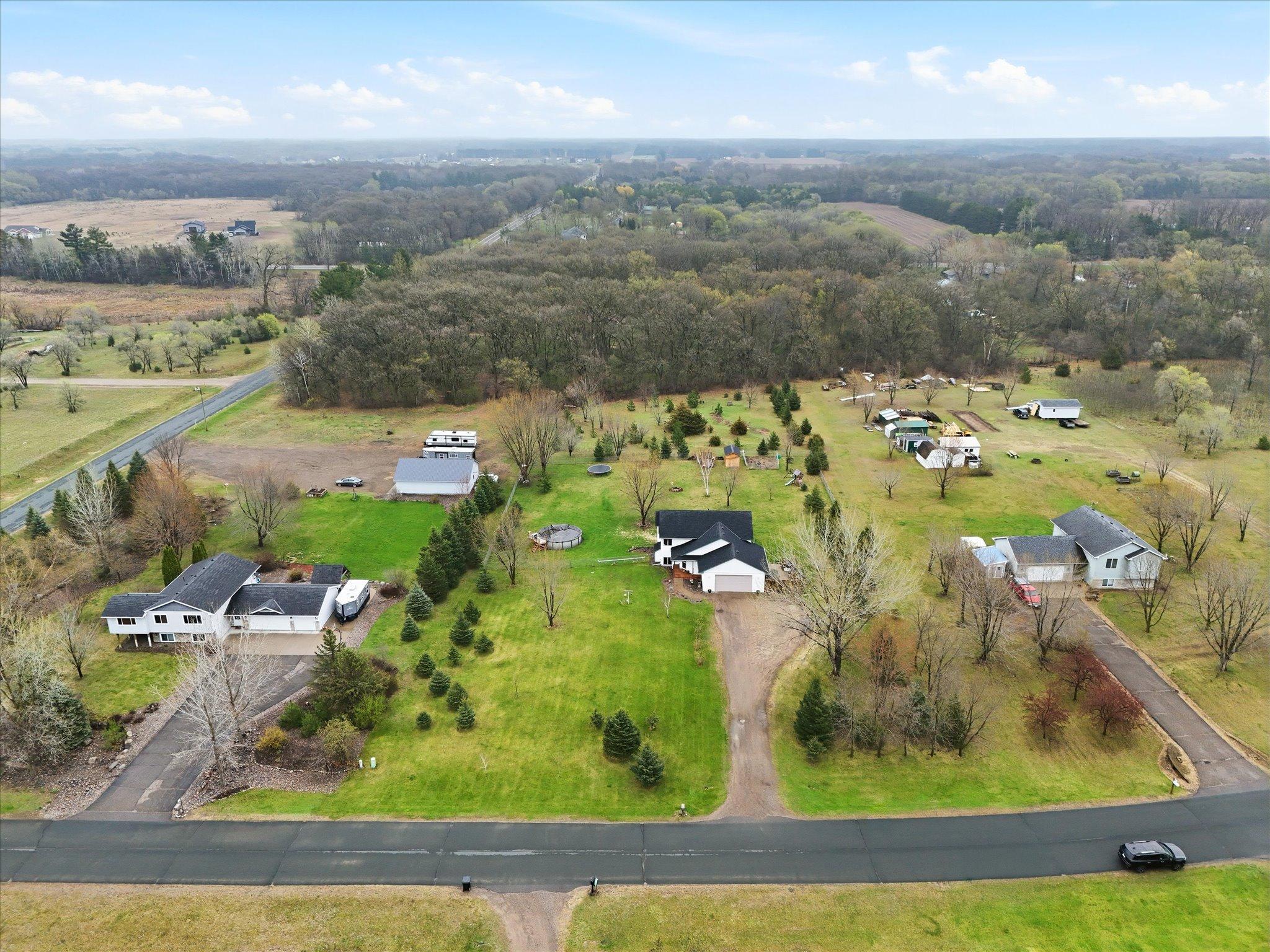 Wooded backdrop at the rear of the property adds natural surroundings