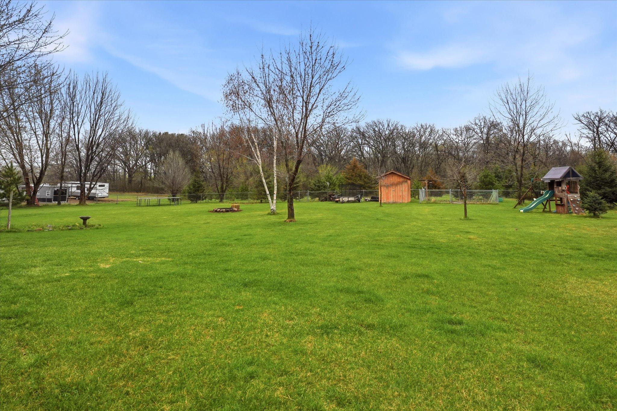 Storage shed for tools, equipment, or seasonal items. Garden space ready for planting and growing.