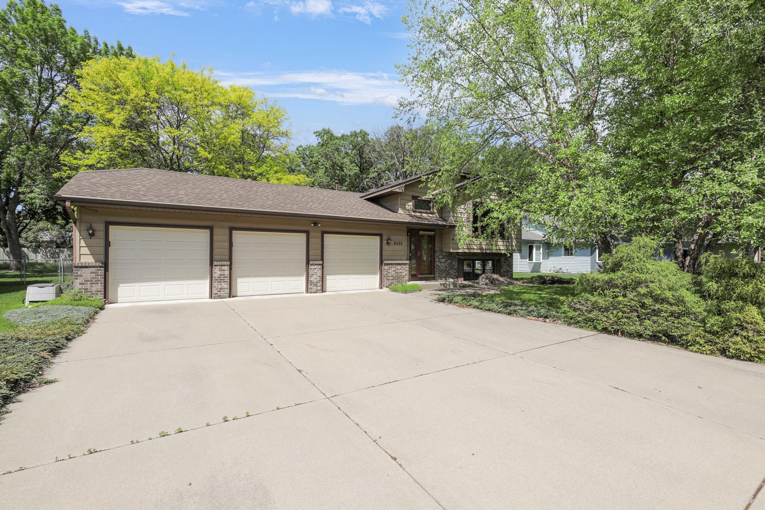 Welcome home! Concrete driveway and a 3 car garage.