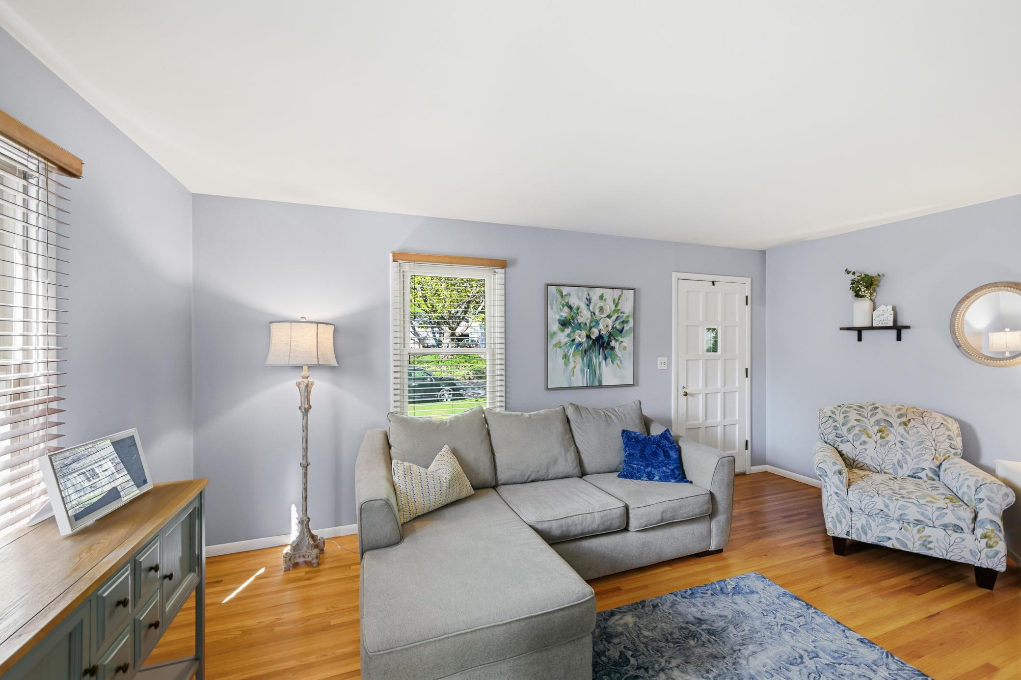 Hardwood floors and large windows make the living room warm and inviting.