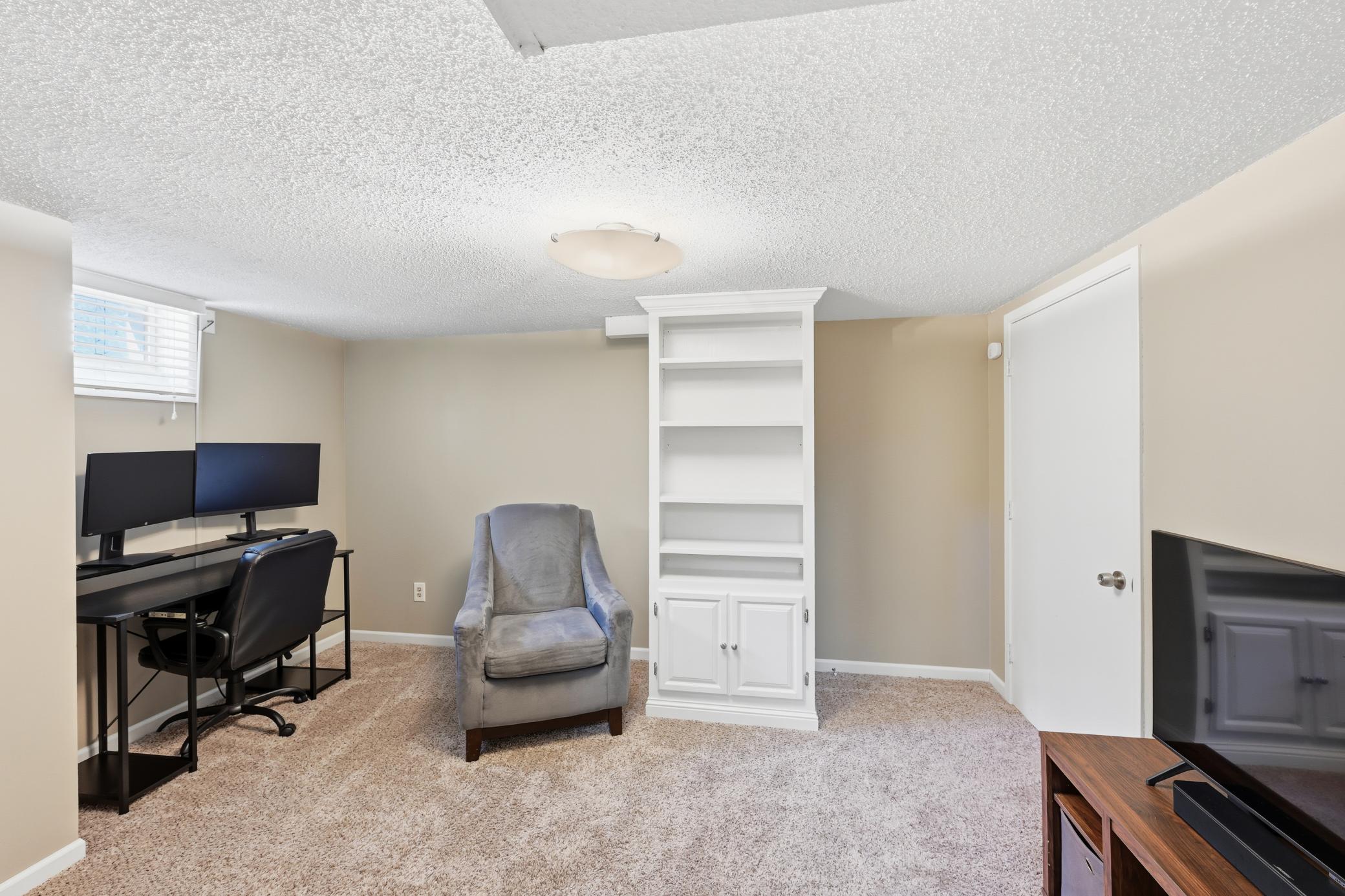Lower level family room offers a place to work from home.