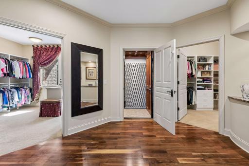 Entry to the elevator from the Primary bedroom, flanked by His and Hers walk-in closets