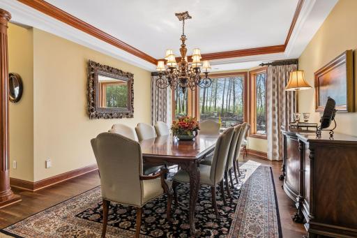 Formal dining room with walnut floors and cove ceiling