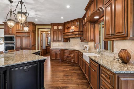 Professional-grade appliance suite with SubZero cabinet-front refrigerator and double Wolf ovens