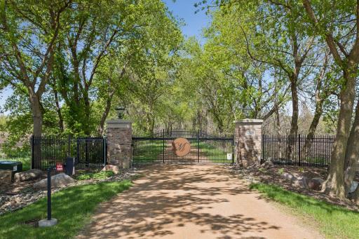 Private gated entrance with integrated security cameras and coded access