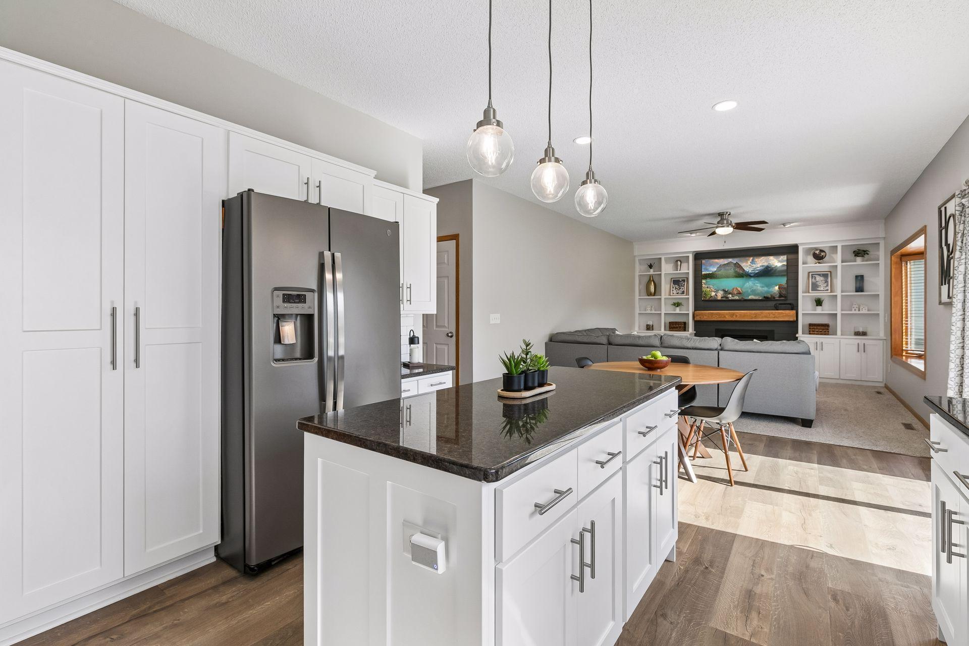 The open-concept layout connects the kitchen to the informal dining and family room areas. The pantry and additional cabinets in the island provide for extra storage.