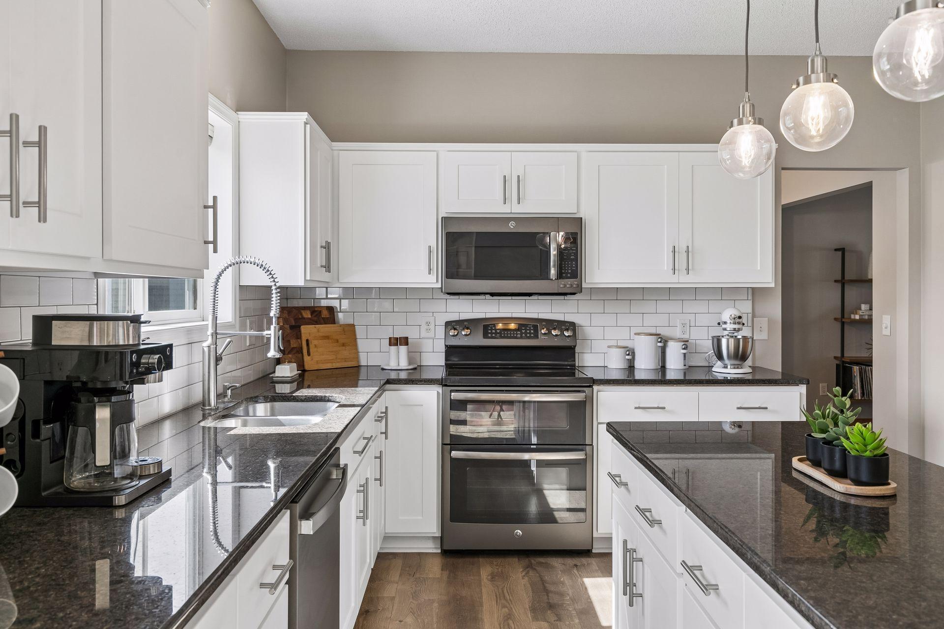 A well-appointed kitchen featuring tile backsplash, updated fixtures, and ample prep space.