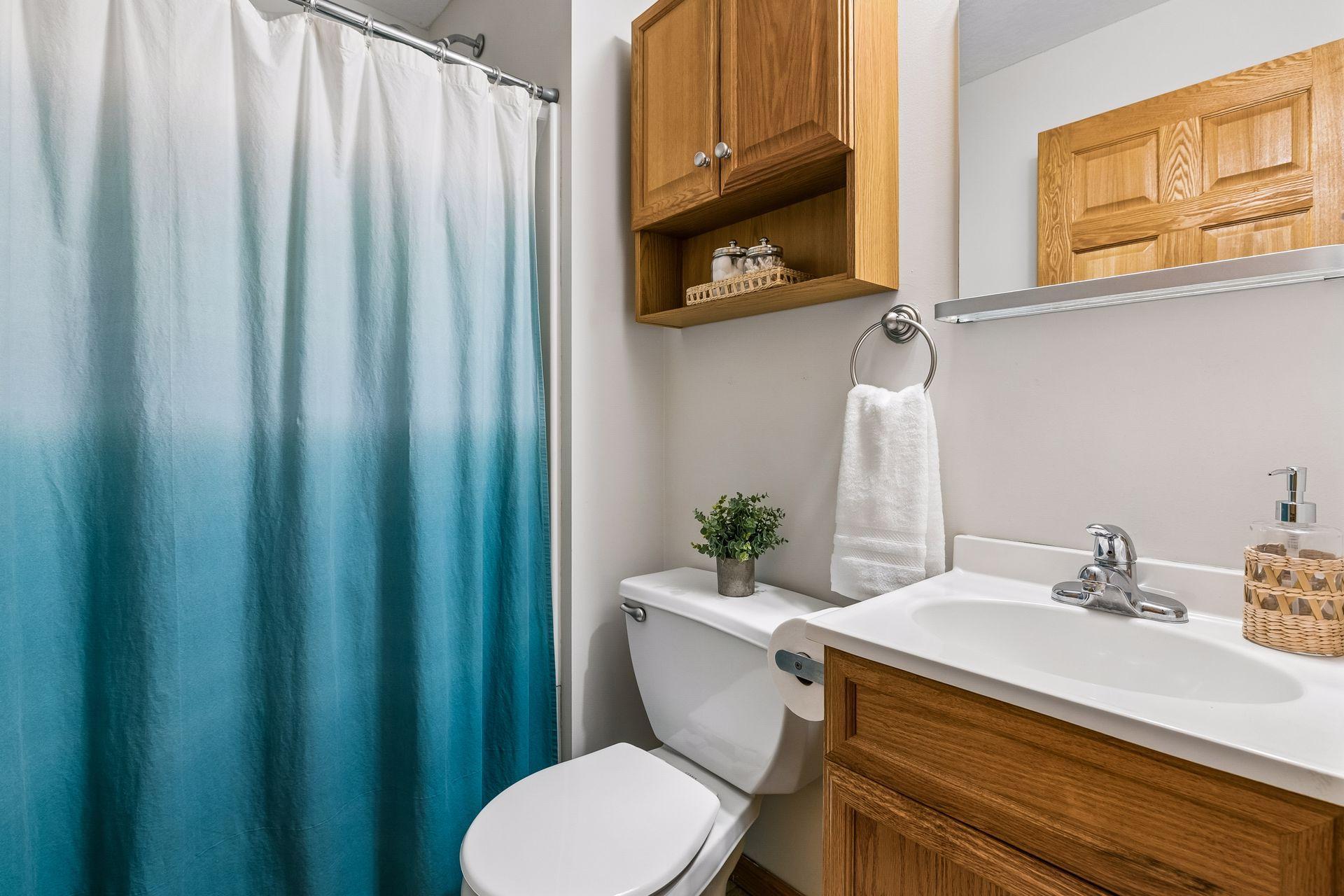 The fourth bathroom is a three-quarter bath with classic finishes and is convenient for guests or lower-level use.