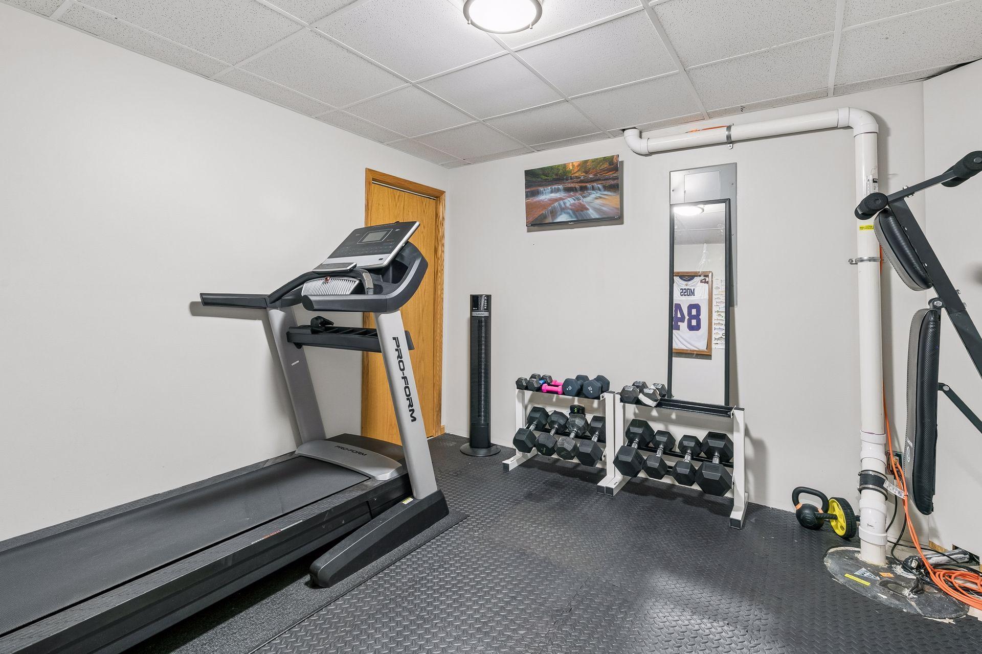 This room in the lower level is currently a dedicated exercise space, but could also serve as a playroom, hobby room, or storage.