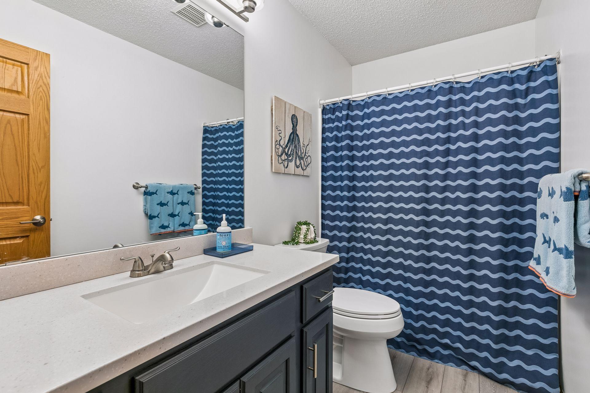 The upper-level full bathroom has been updated and features ample counter space and a clean, functional layout.
