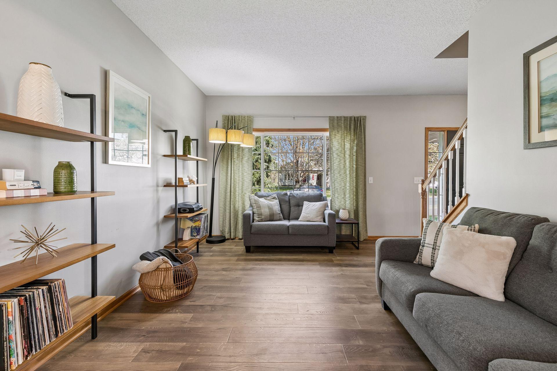 This comfortable living room is filled with natural light from the large front window. The Pergo floors continue from the entryway and are throughout most of the main level.