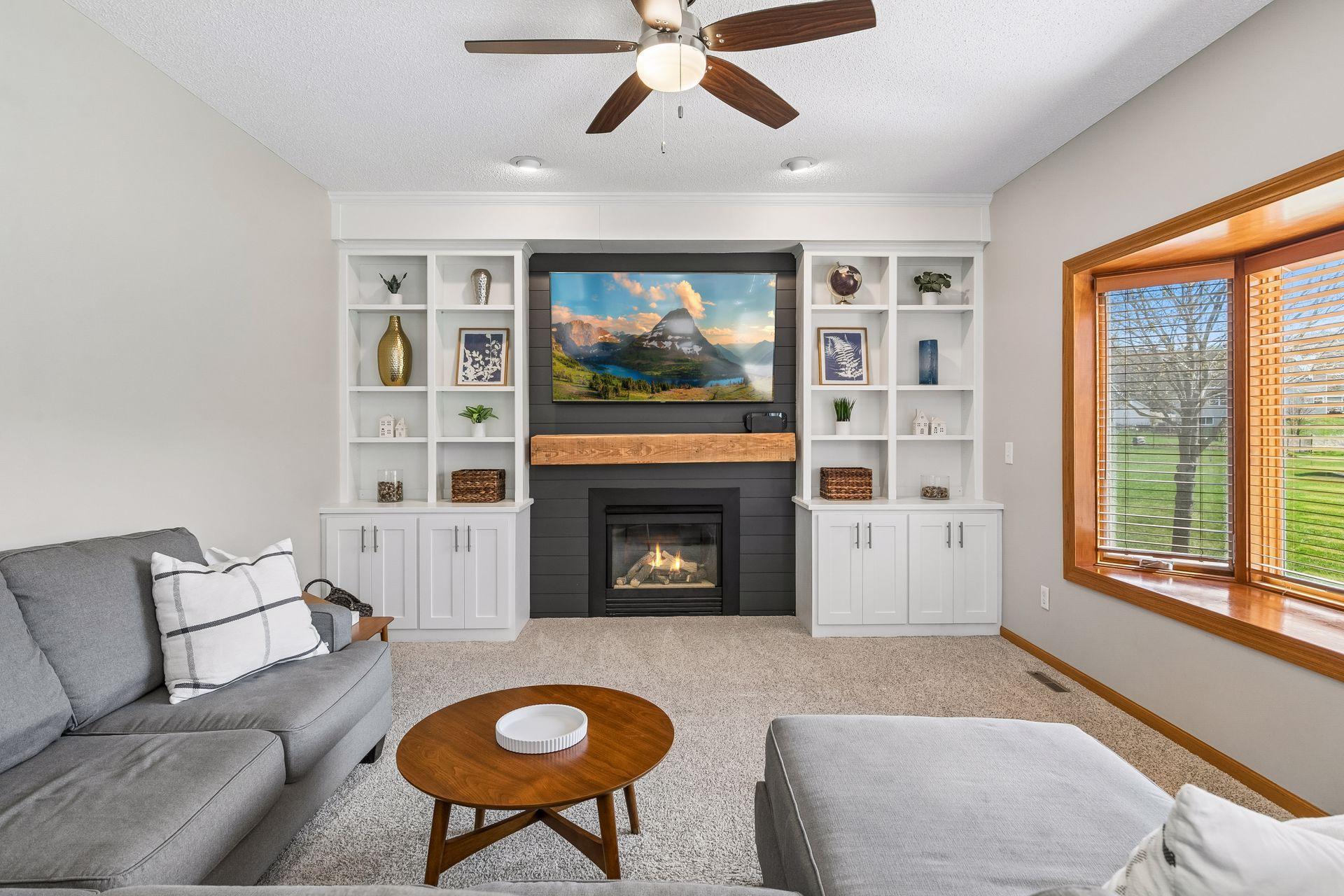 The inviting family room features custom-built-in cabinetry and a cozy gas fireplace, offering a warm, comfortable, and relaxing space.