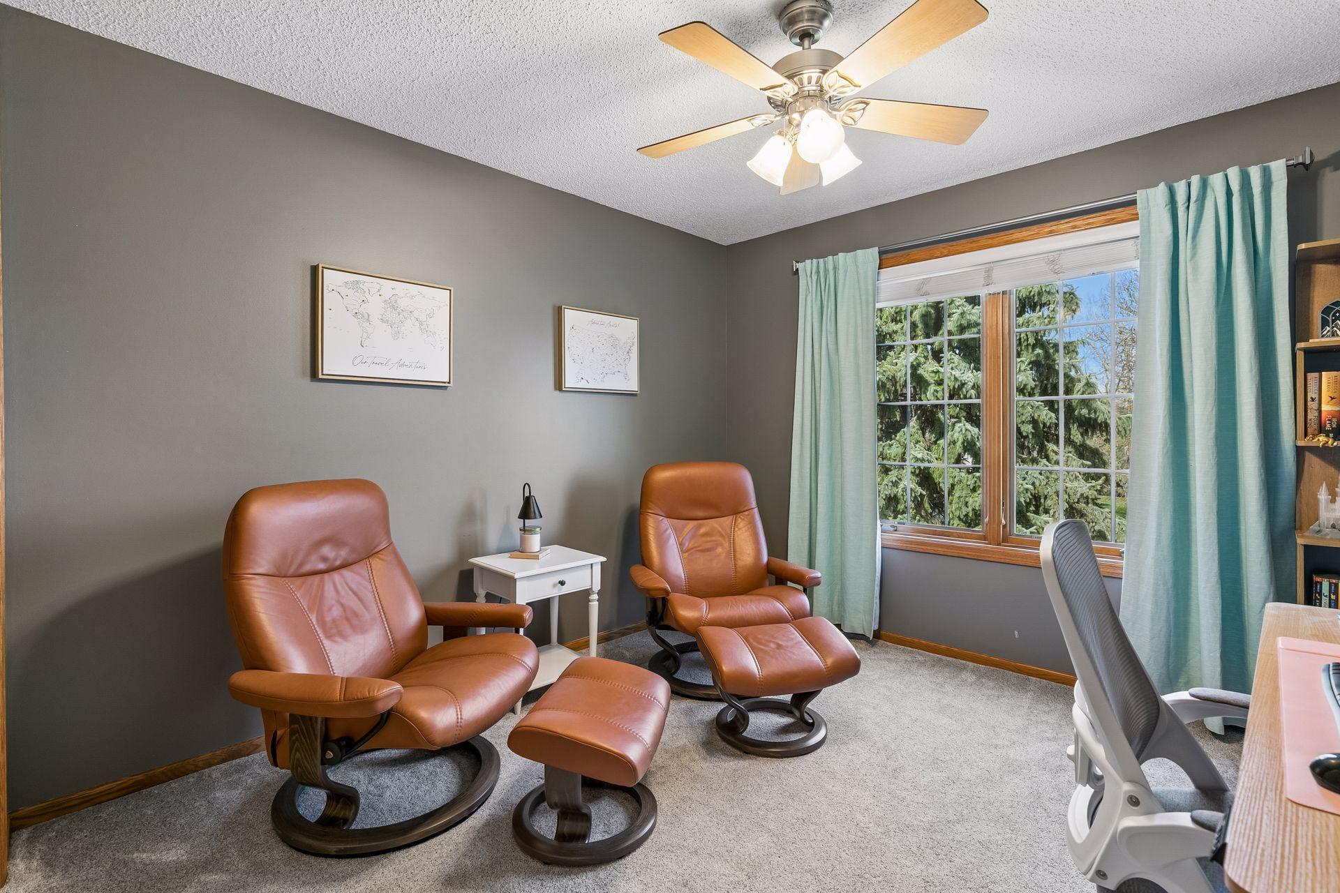 The second bedroom on the upper level is currently used as an office and features neutral finishes and a large window.