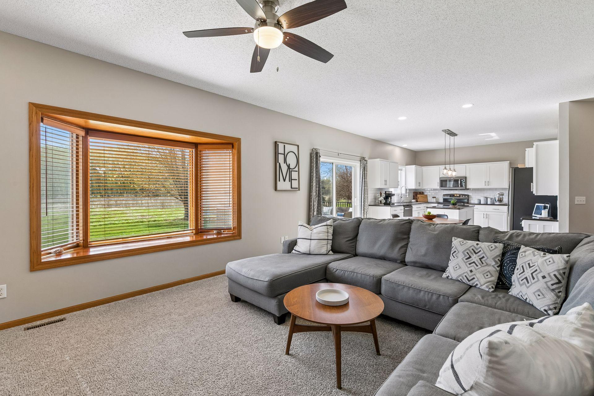This spacious family room also features a large bay window, open sightlines to the kitchen and informal dining area, and views of the backyard.