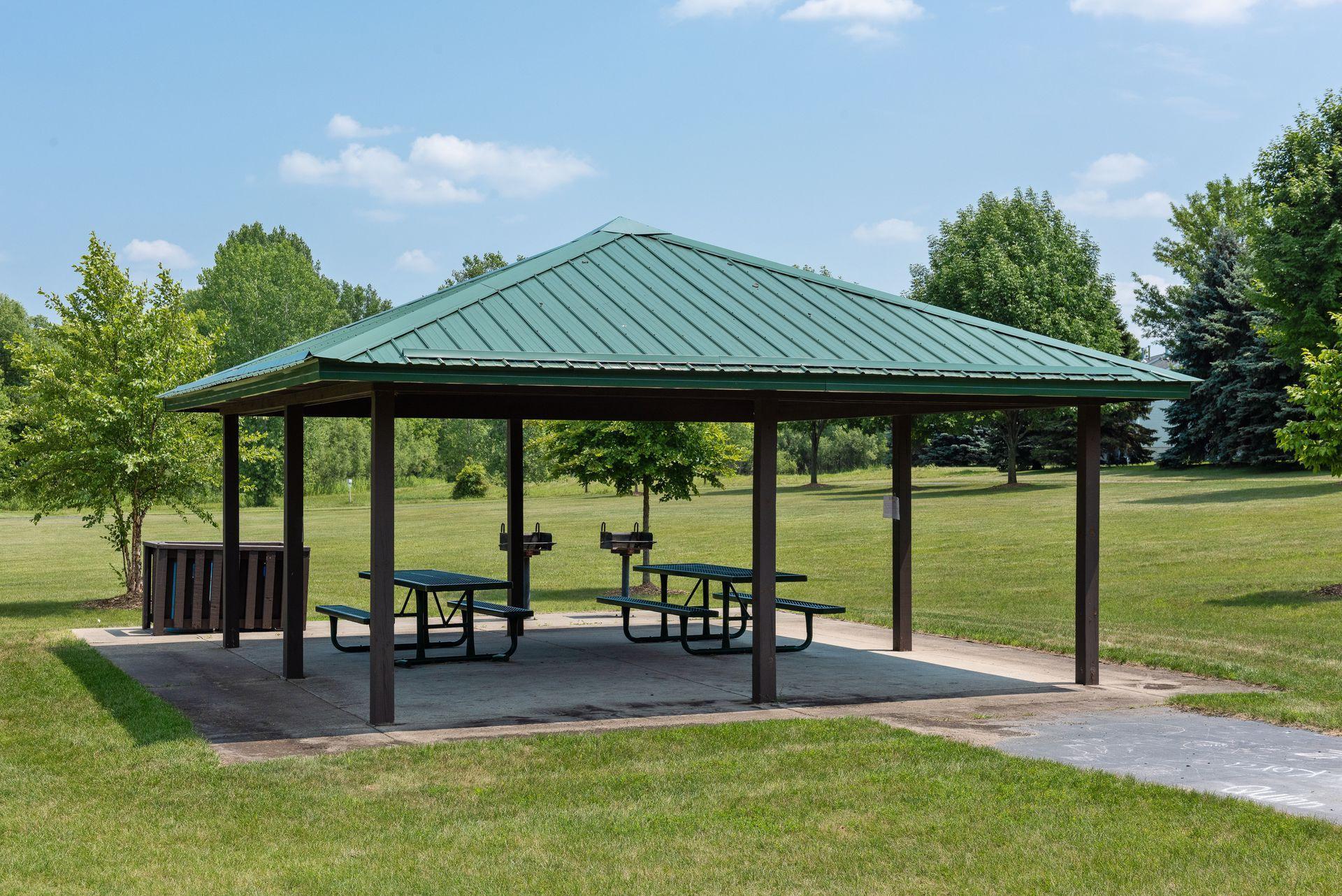 Eagle Creek Park's covered picnic pavilion with seating and grills. Ideal for relaxing or outdoor get-togethers.