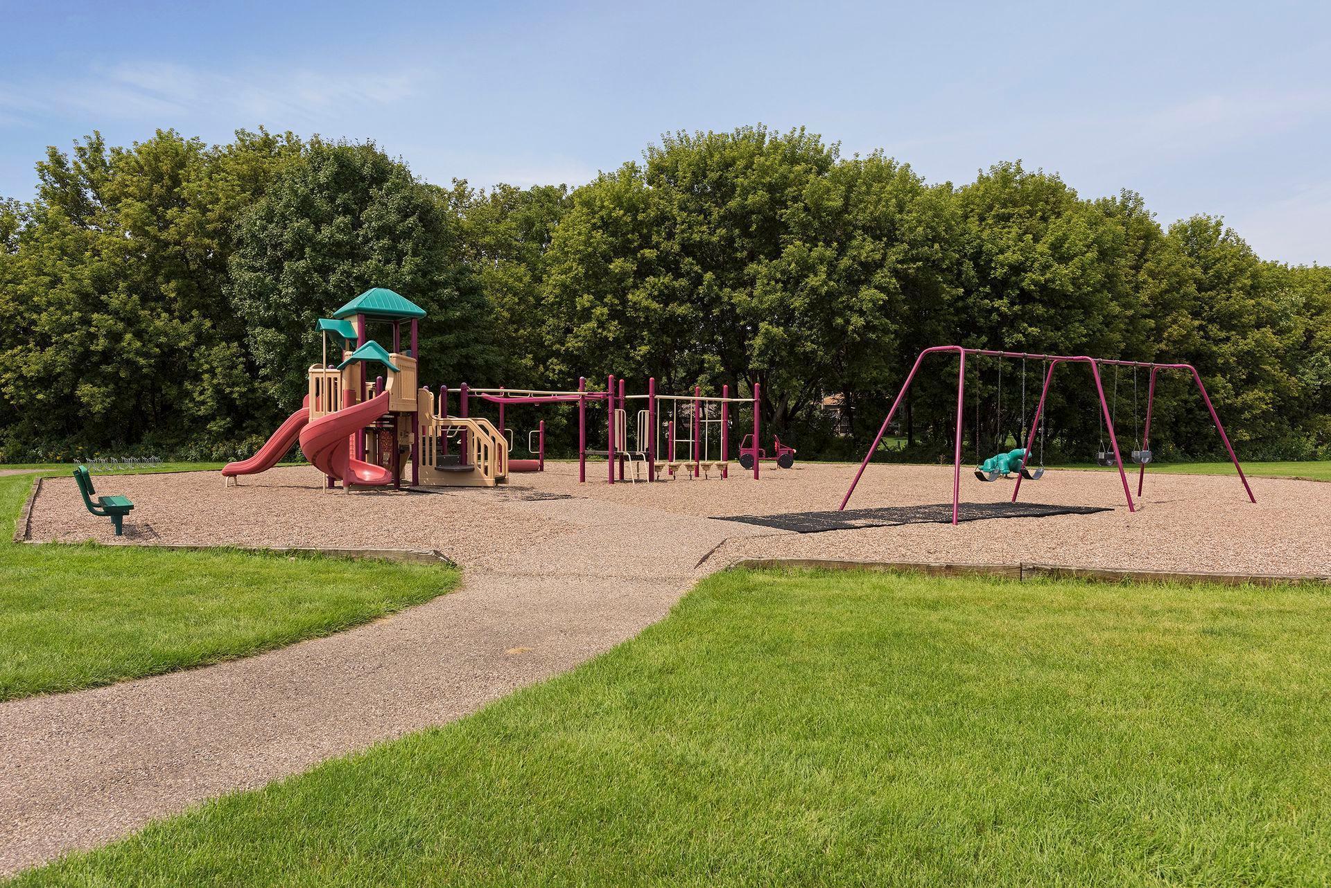 Schroeders Acres Park's playground space with swings and play structures.