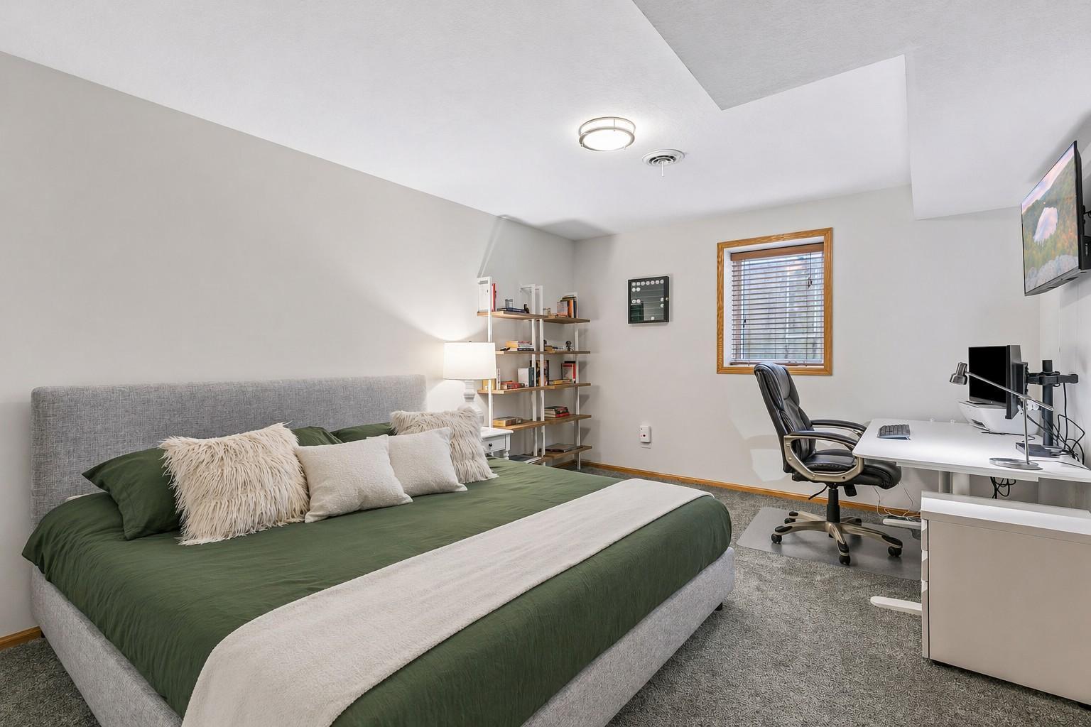 The fourth bedroom in the lower level is spacious enough for a king-sized bed and provides an additional flexible space for guests, work-from-home, or hobbies.