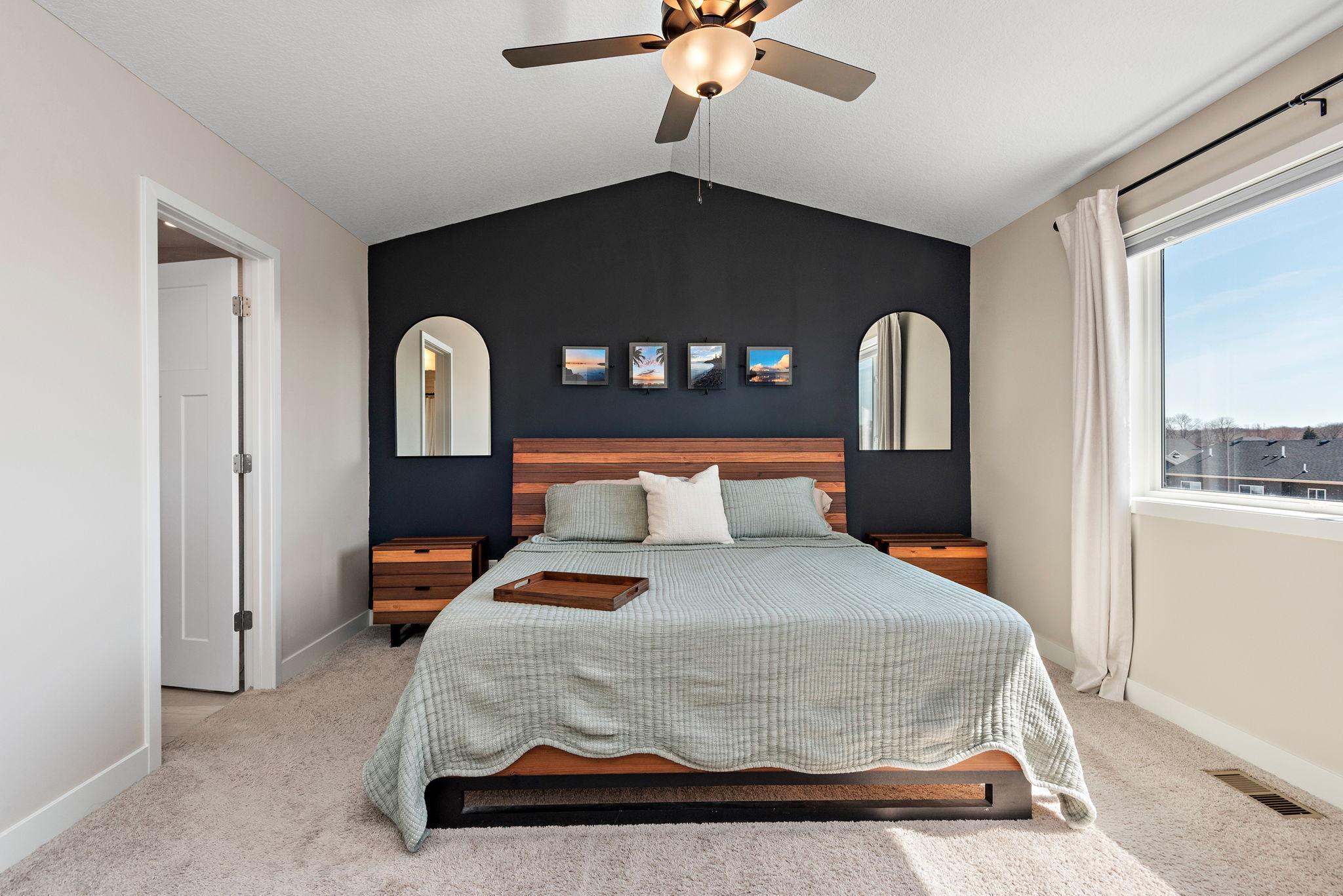 Luxury, upper level primary suite featuring vaulted ceilings, separate soaking tub & tiled shower, duel sinks & walk-in closet with custom closet system