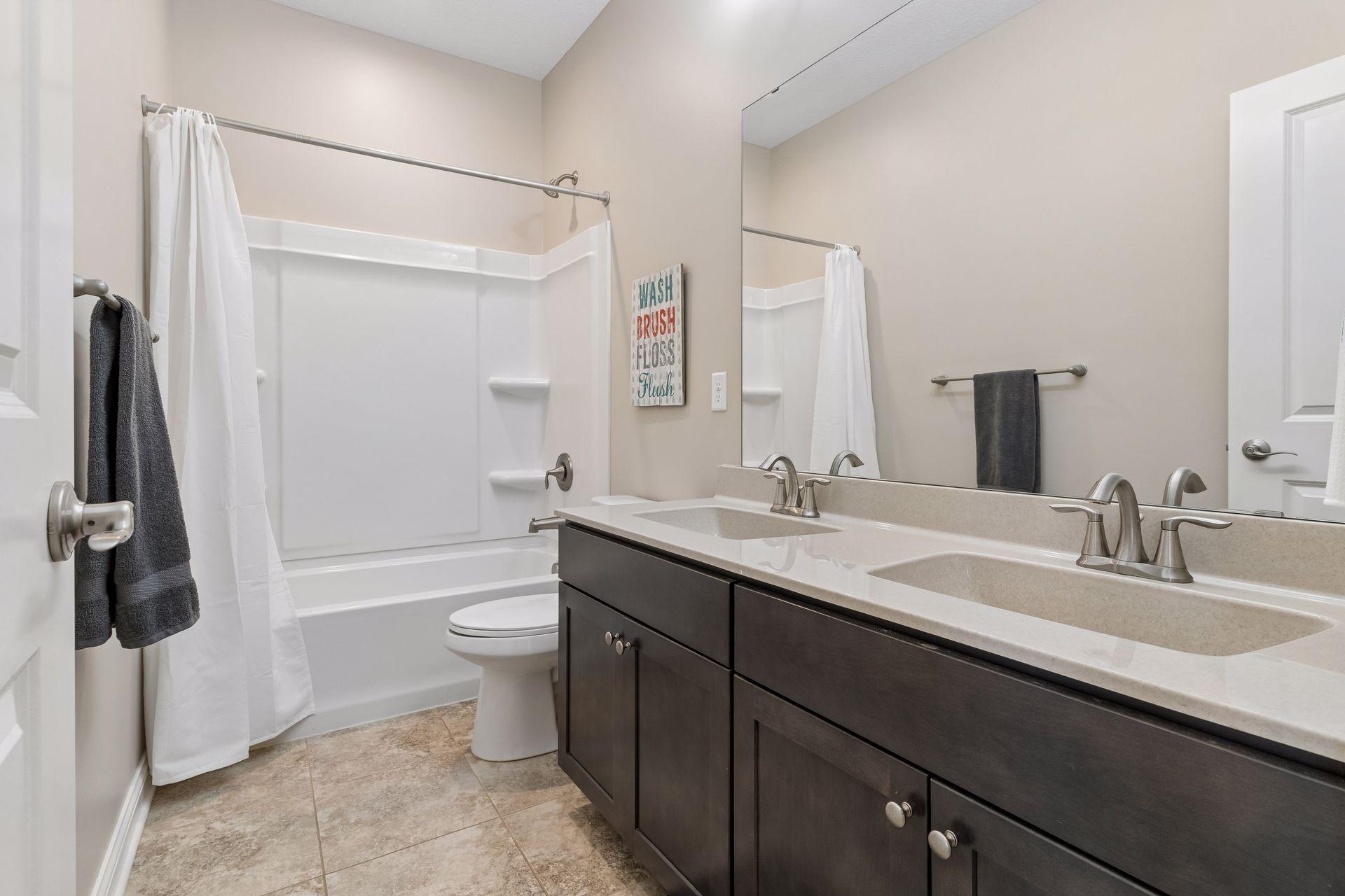 There are a total of three upper level full baths. (One in the primary suite.) There are two additional bathrooms. This is bath two of two.