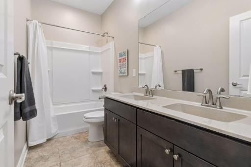 There are a total of three upper level full baths. (One in the primary suite.) There are two additional bathrooms. This is bath two of two.