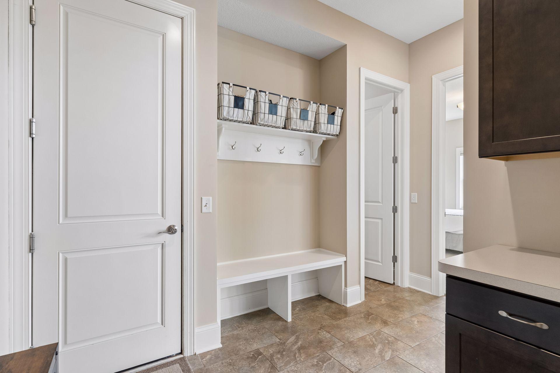 A locker area sits off the garage and bath.