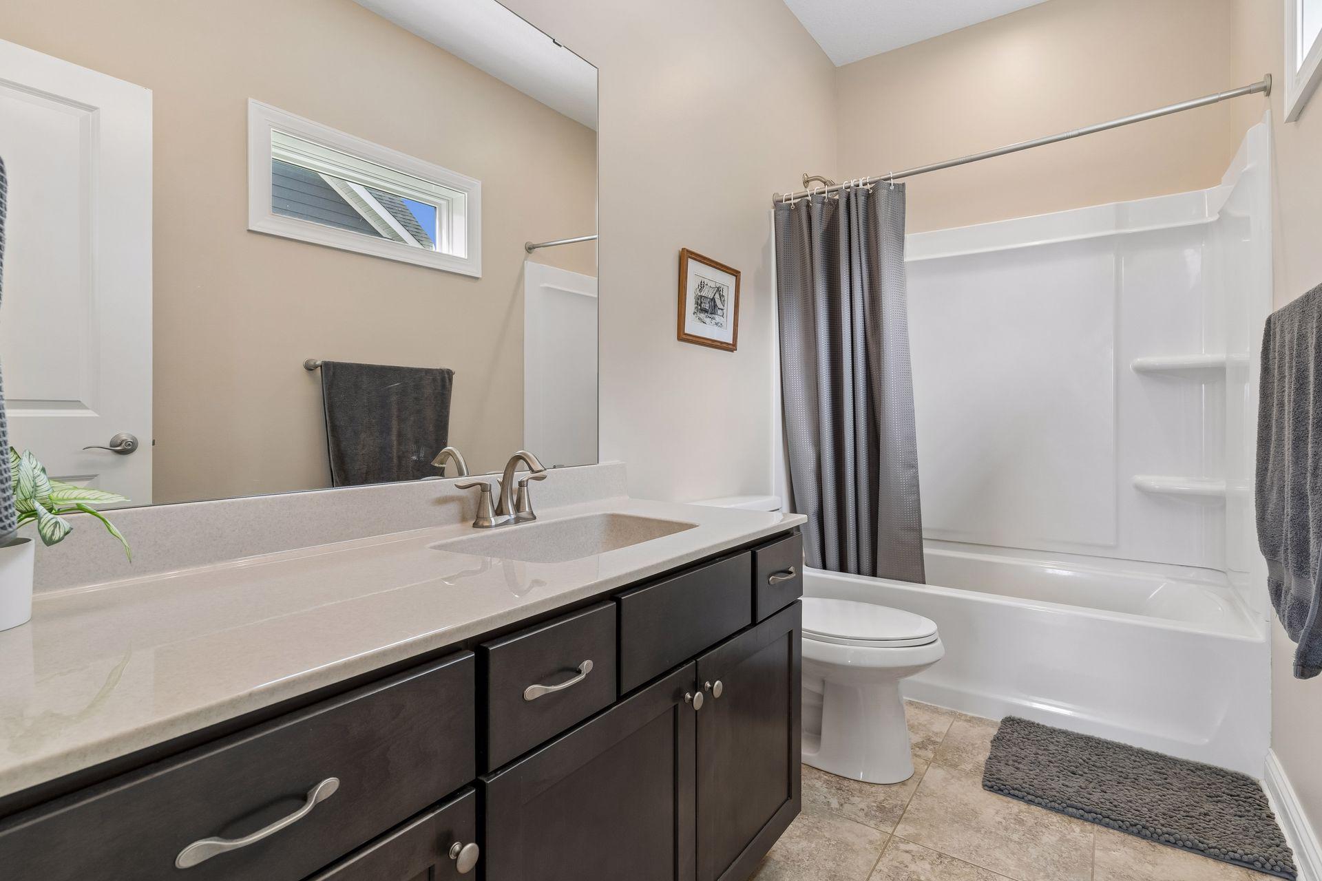 There are a total of three upper level full baths. (One in the primary suite.) There are two additional bathrooms. This is bath one of two.