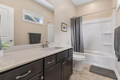 There are a total of three upper level full baths. (One in the primary suite.) There are two additional bathrooms. This is bath one of two.