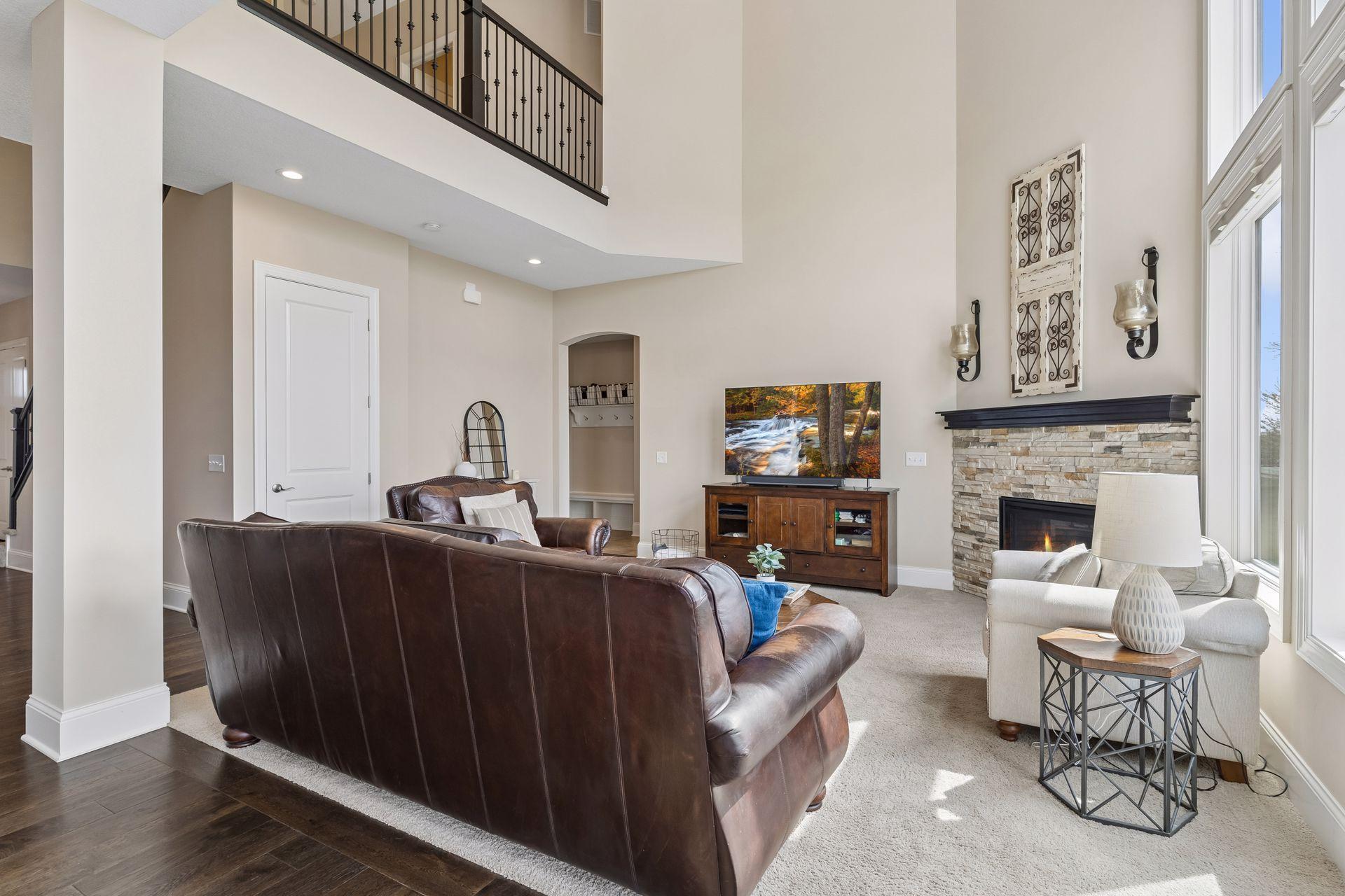 The upper level staircase overlooks this living room area.