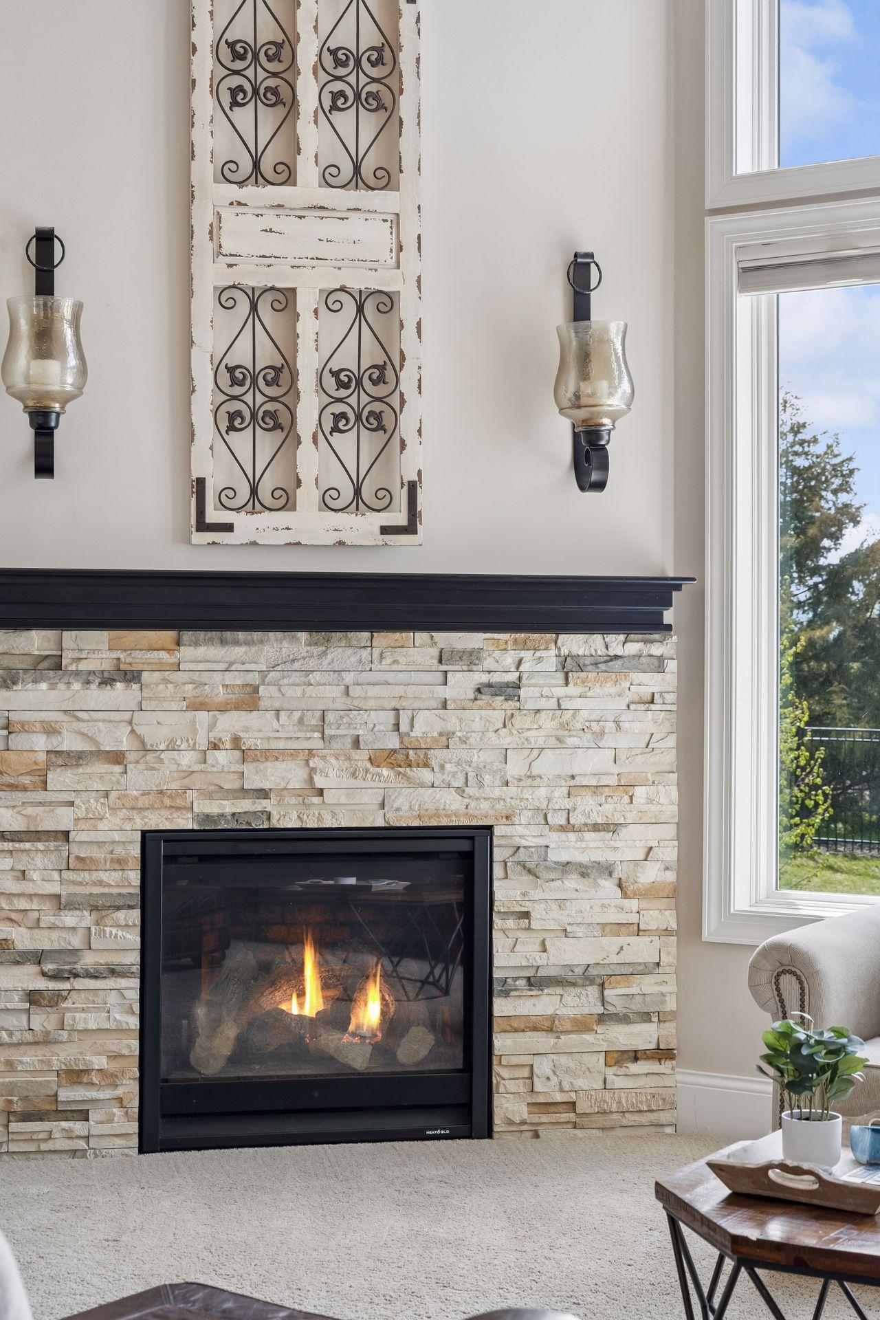 Gorgeous stone surrounds the gas fireplace.