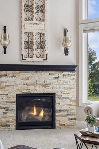 Gorgeous stone surrounds the gas fireplace.