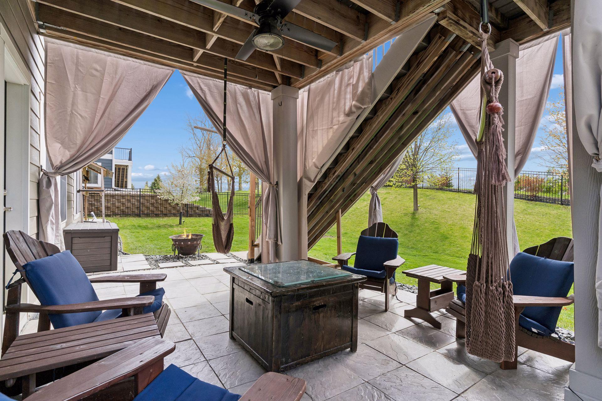 The lower level private patio has pavers and a ceiling fan for ambiance.