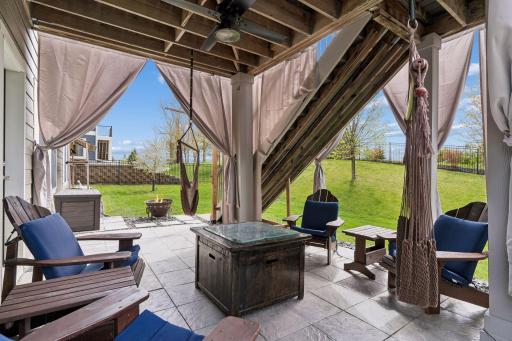 The lower level private patio has pavers and a ceiling fan for ambiance.
