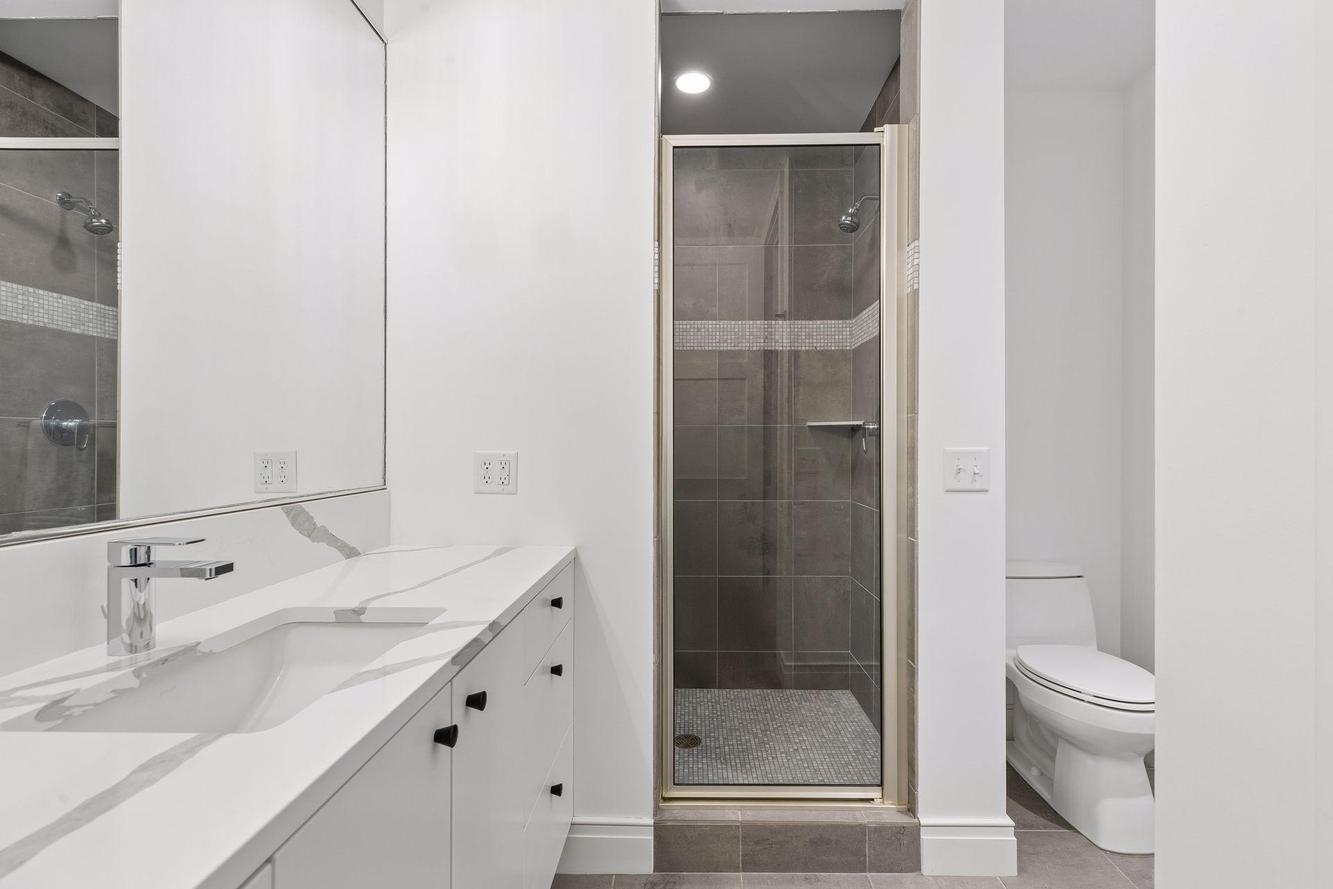 En-suite 3/4 bathroom with walk-in shower and new countertops