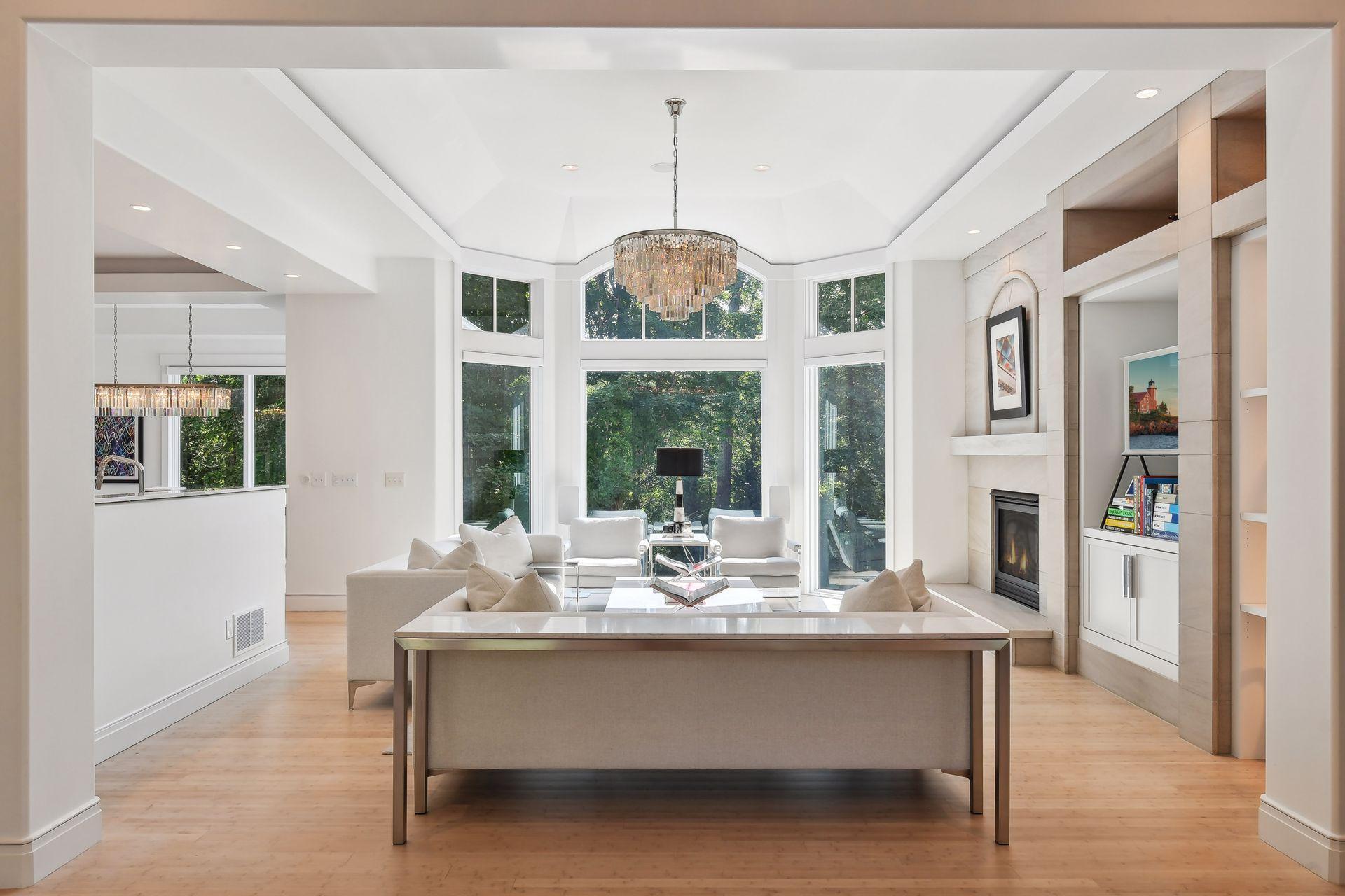 Step inside to be greeted by soaring ceilings, bamboo flooring, and striking oversized windows with views of the private backyard