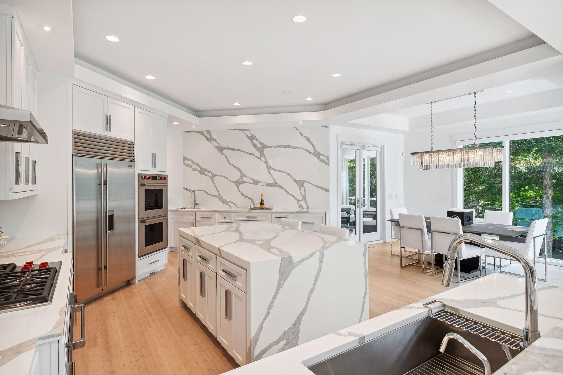 Kitchen flows seamlessly into dining space and sun room