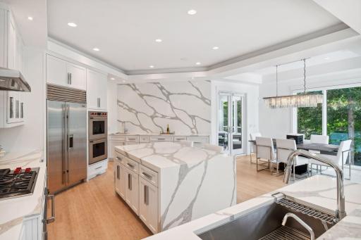 Kitchen flows seamlessly into dining space and sun room