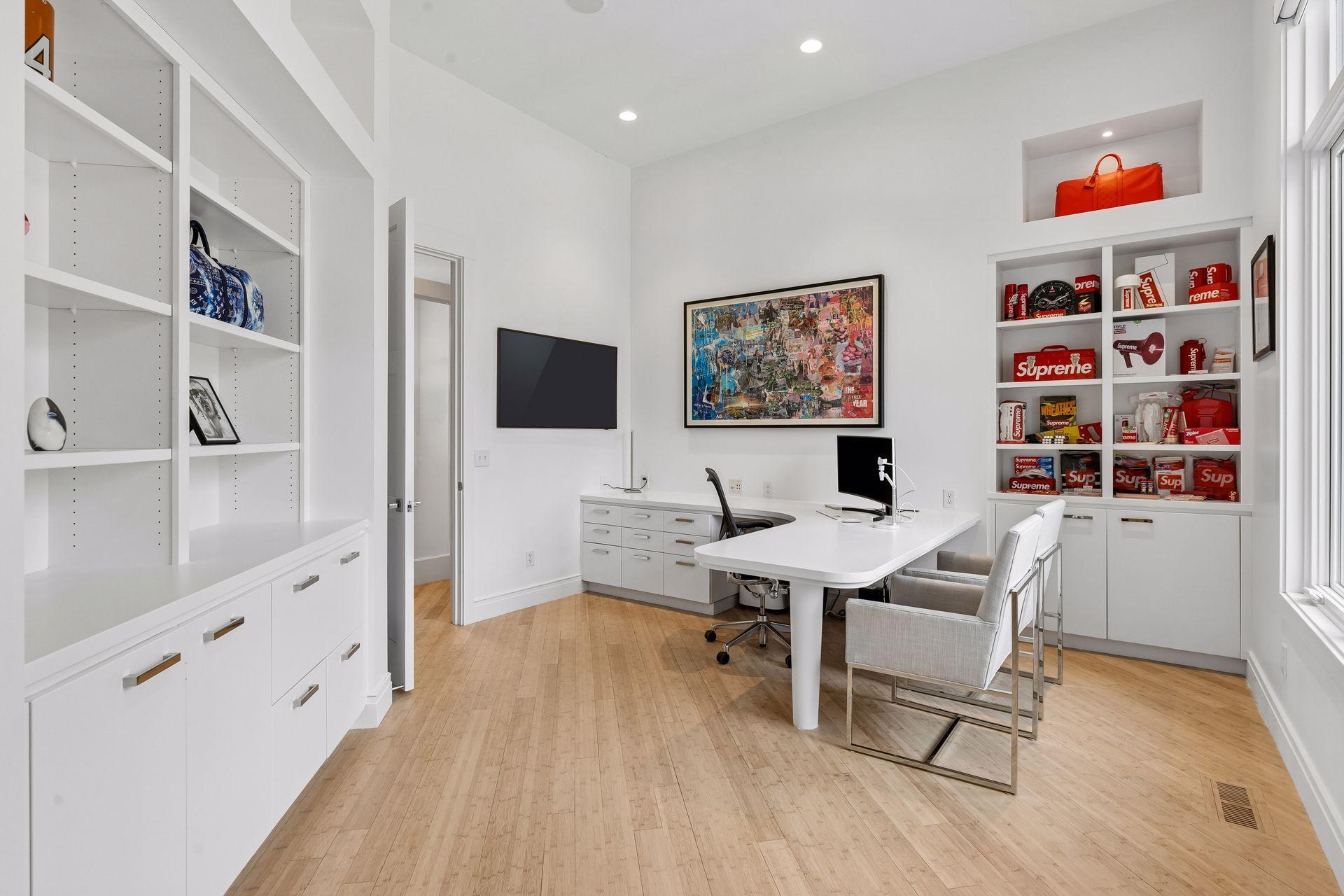 Main floor office with built in storage for displaying artwork or showcasing decor.