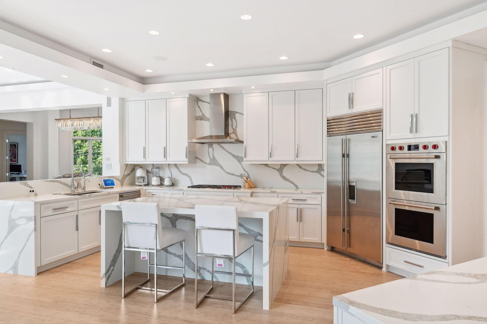 Kitchen features premium stainless steel appliances, center island with seating, and tons of natural light