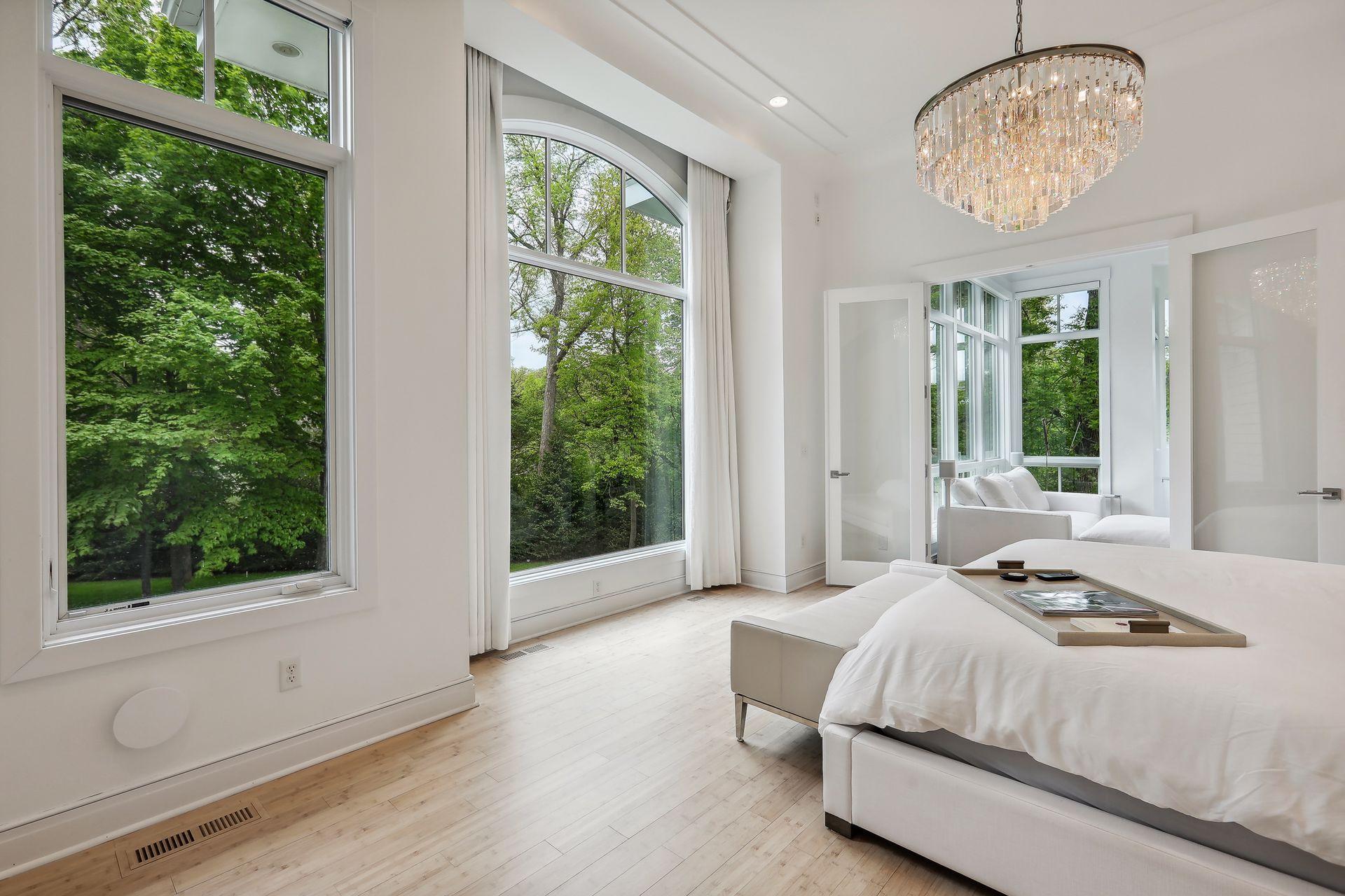 Gorgeous oversized windows and bamboo flooring throughout the primary bedroom