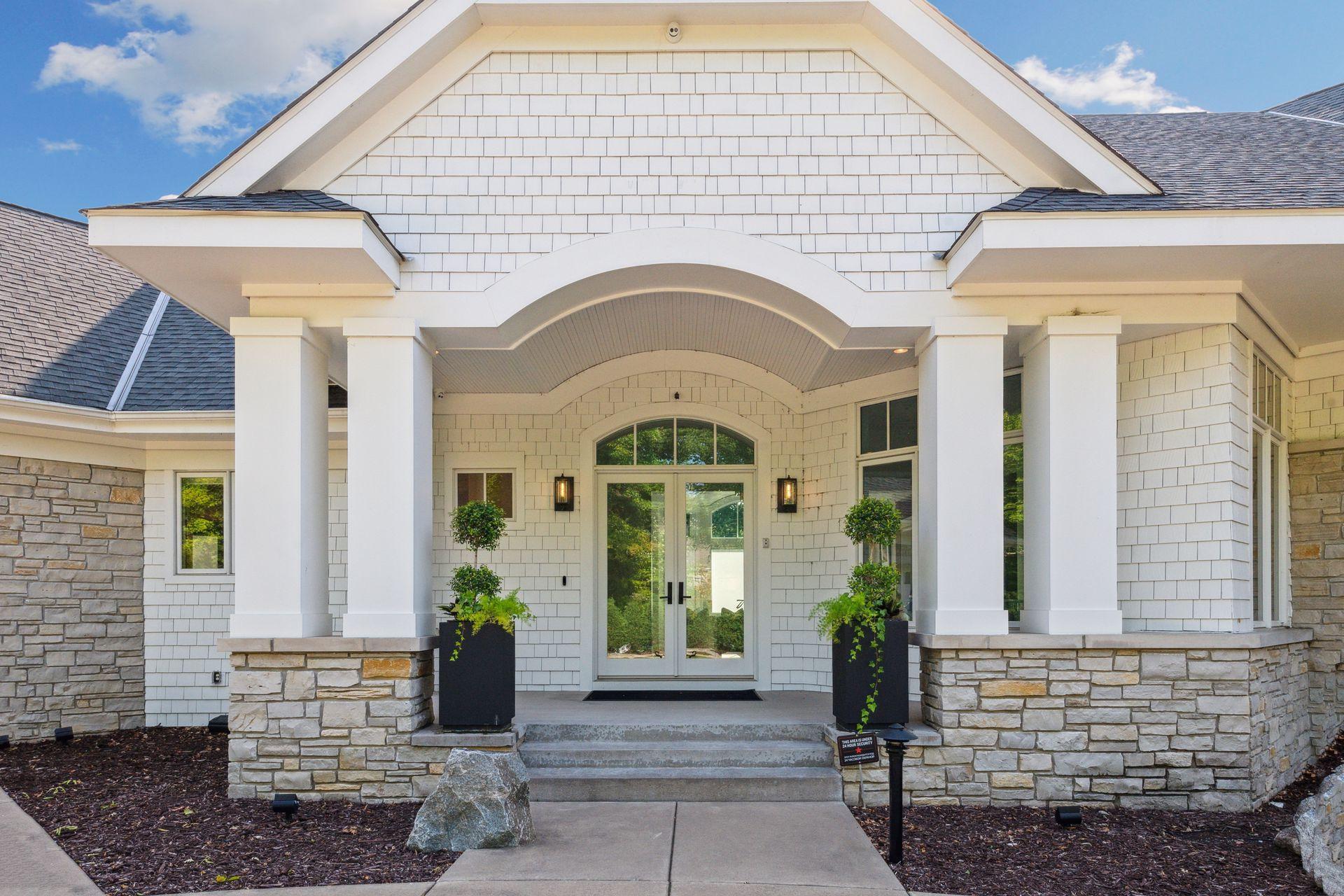 Grand entryway with stately columns, stone accents, and timeless curb appeal