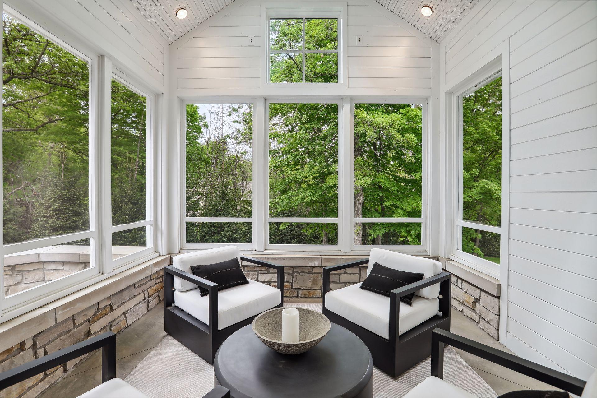 Stunning light filled sun room with oversized windows and tons of natural light