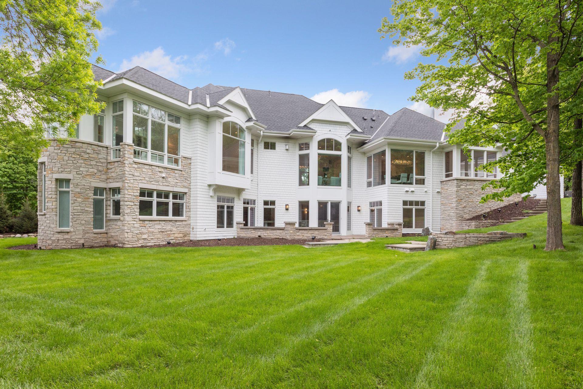 Expansive walk-out lower level opens to a lush, tree-lined backyard offering ultimate privacy.
