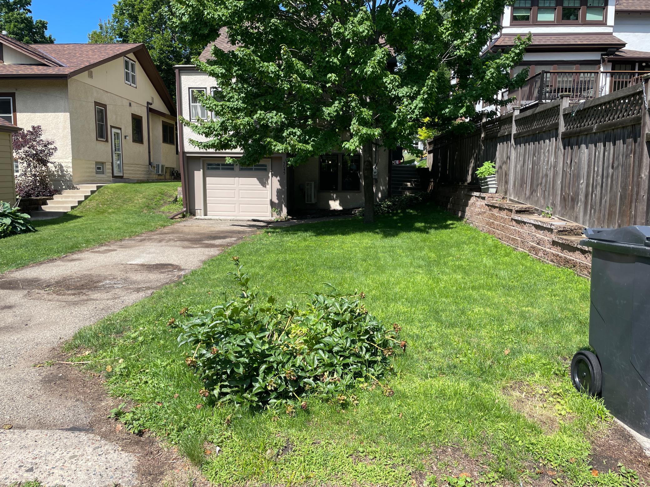 Long driveway and attached garage provide valuable off-street parking and everyday convenience.