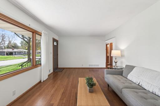 Front entry into living room, hallway to bedrooms, dining area, kitchen