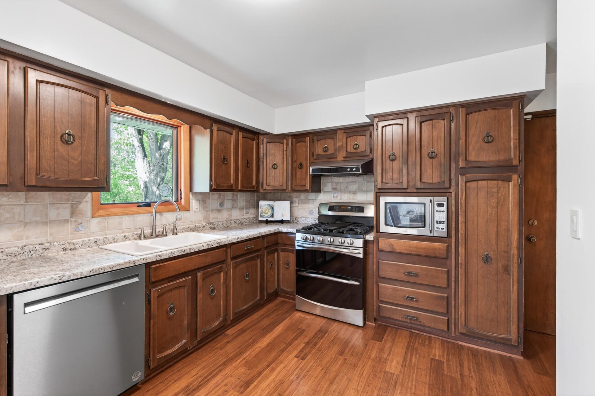 Kitchen window looks out into the spacious backyard