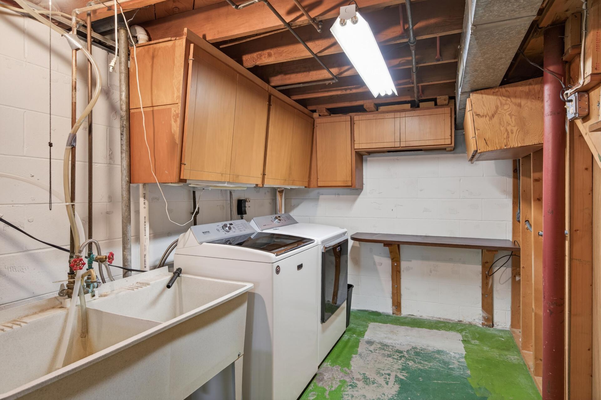 Laundry with newer washer & dryer, folding table, cabinet storage