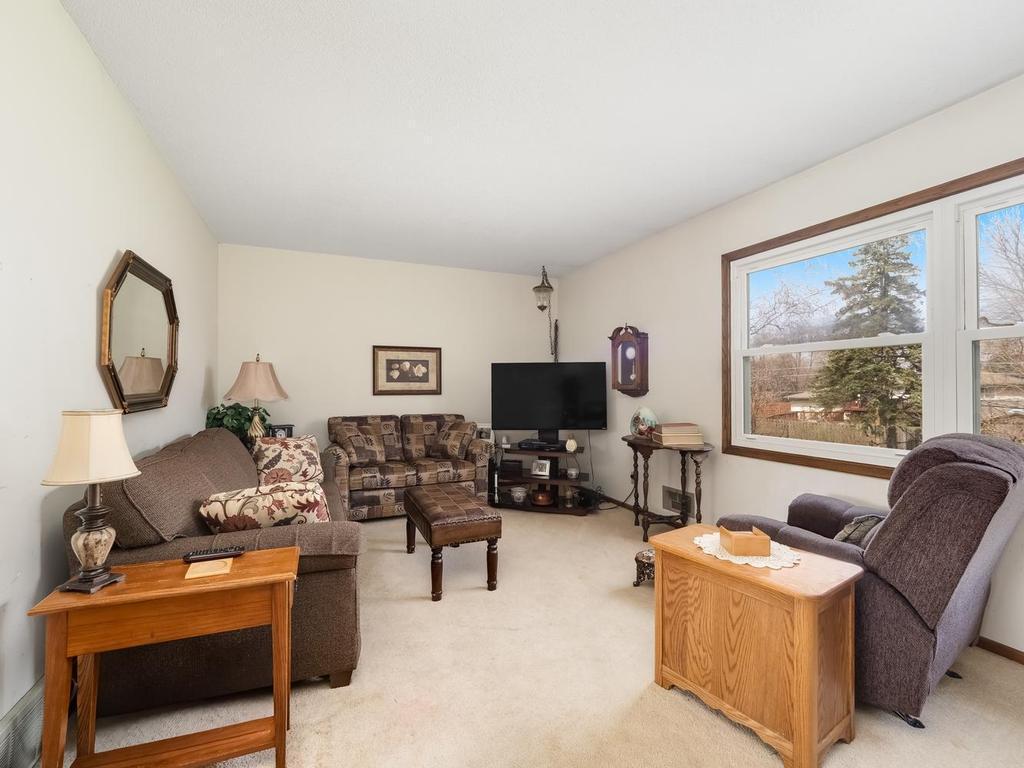 Living room features newer windows. Sorry there is not hardwood floor under carpet.