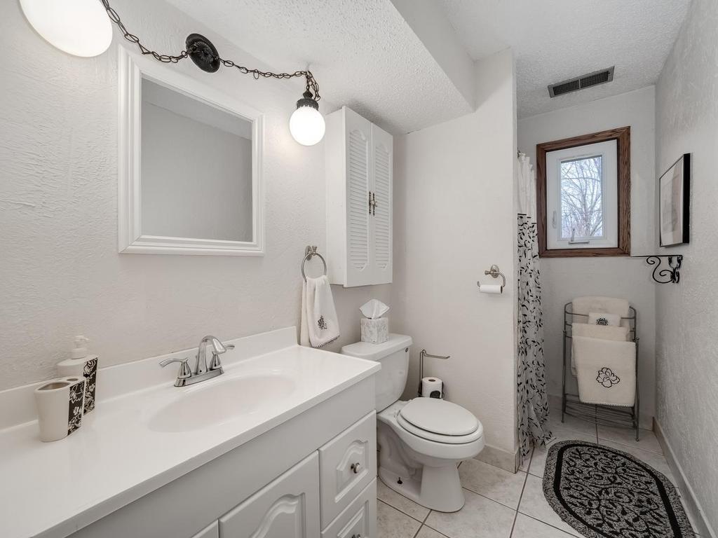 Lower level 3/4 bath with shower has been updated . tile floor