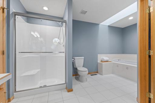 Primary bath - Newly resurfaced shower with new shower doors. A large jetted tub for soaking, tile floors and large walk-in closet.
